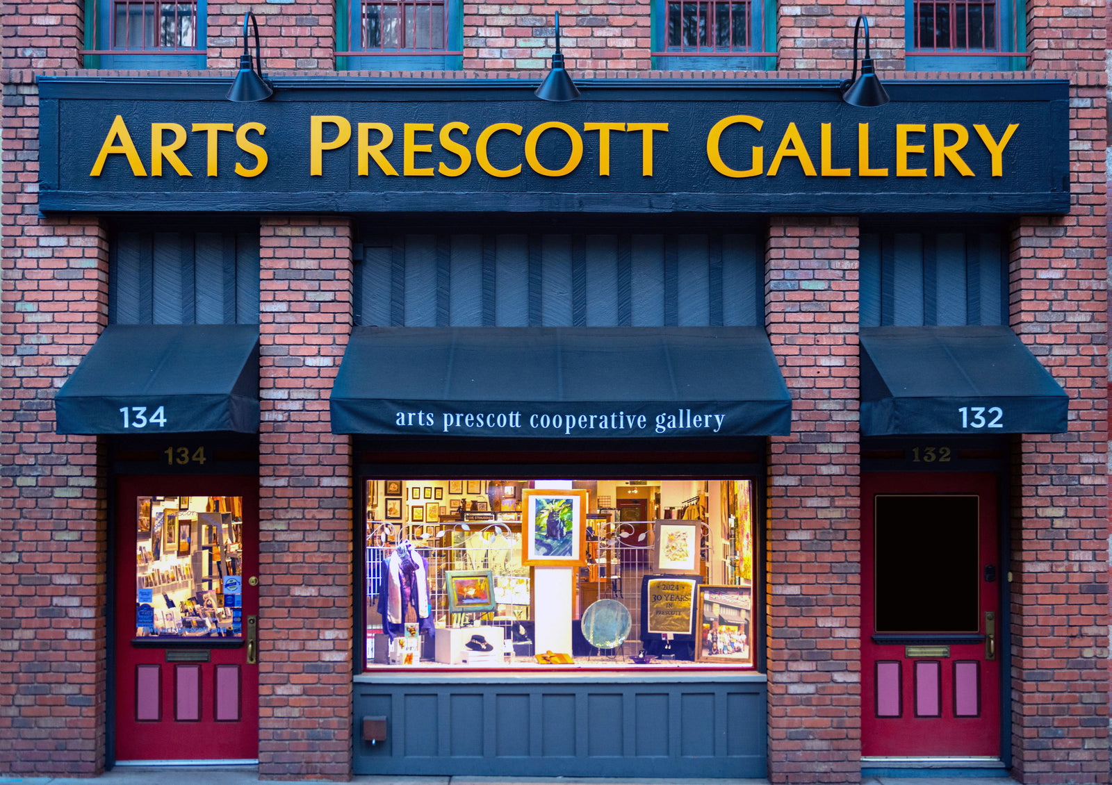 Art's Prescott Gallery with brick facade and glass windows displaying art.