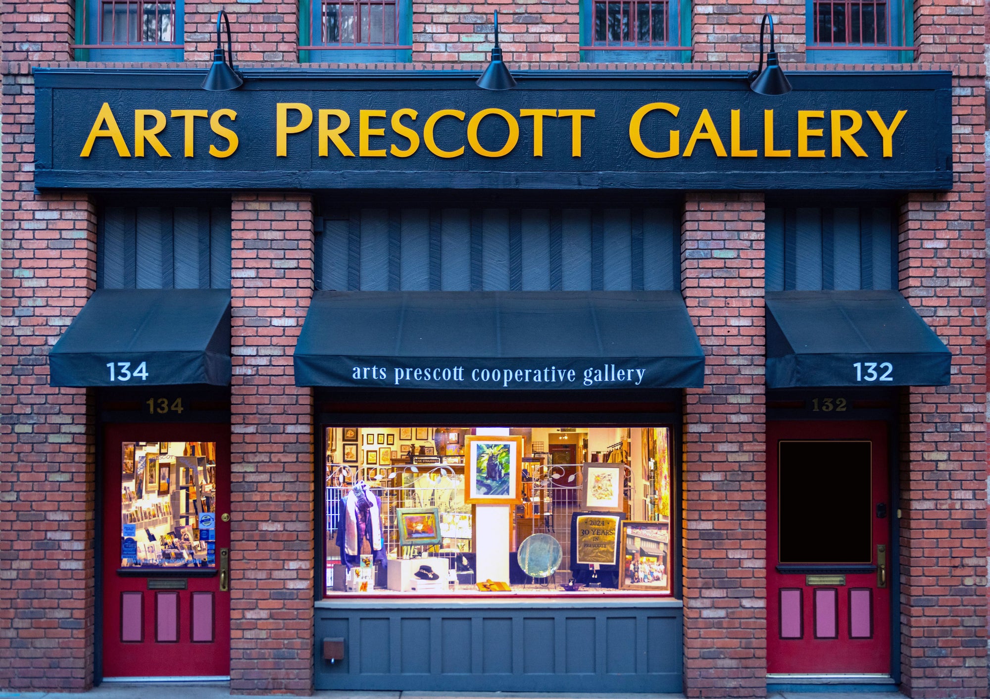 Art's Prescott Gallery with brick facade and glass windows displaying art.
