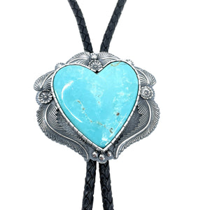 Detail of Turquoise Mountain heart bolo with cast sterling silver flowers and leaves, black braided cord, handcrafted silver Western jewelry