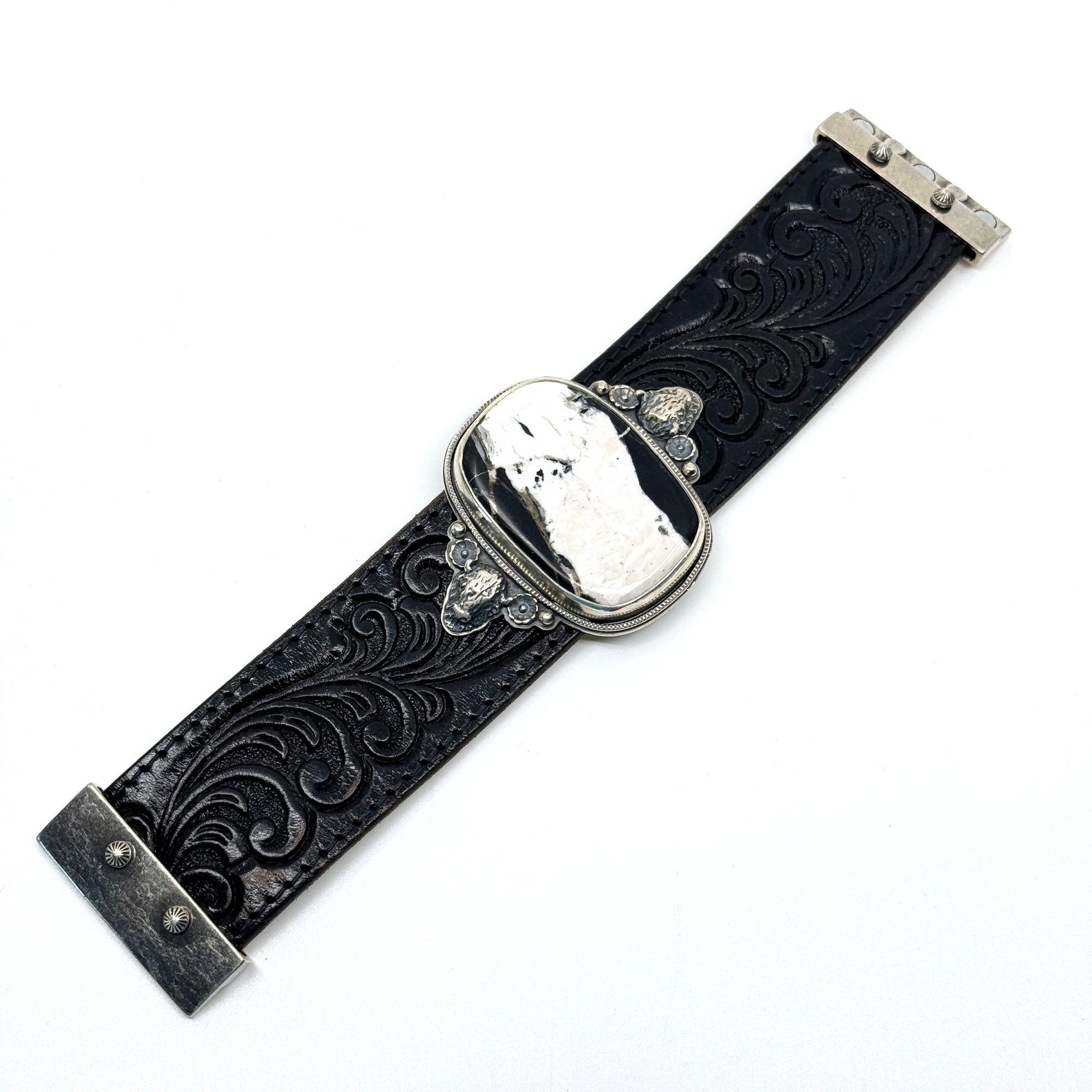 Flat view of Leather cuff bracelet with White Buffalo stone on black western leather belt