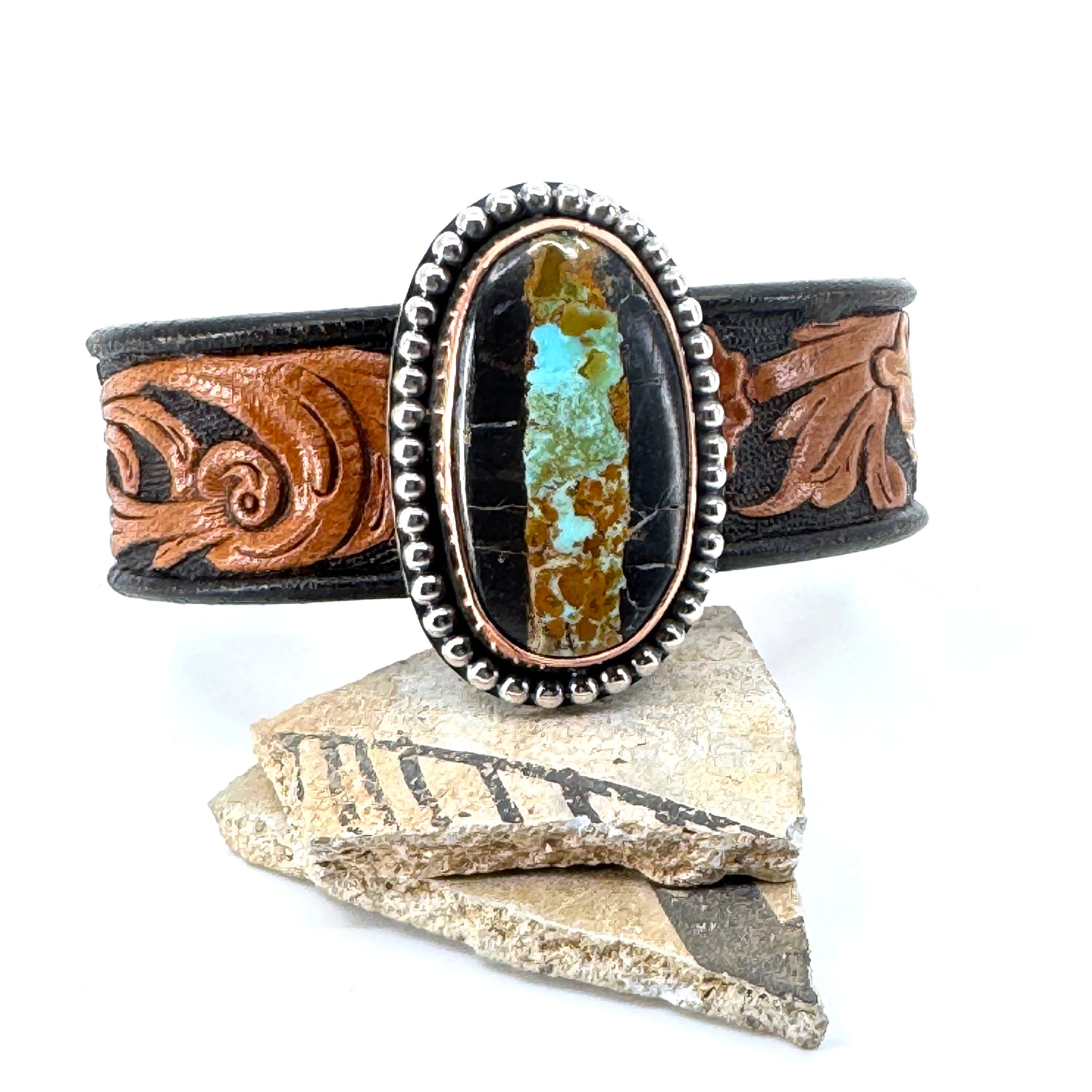 Leather cuff bracelet with Blackjack turquoise stone on floral western leather belt
