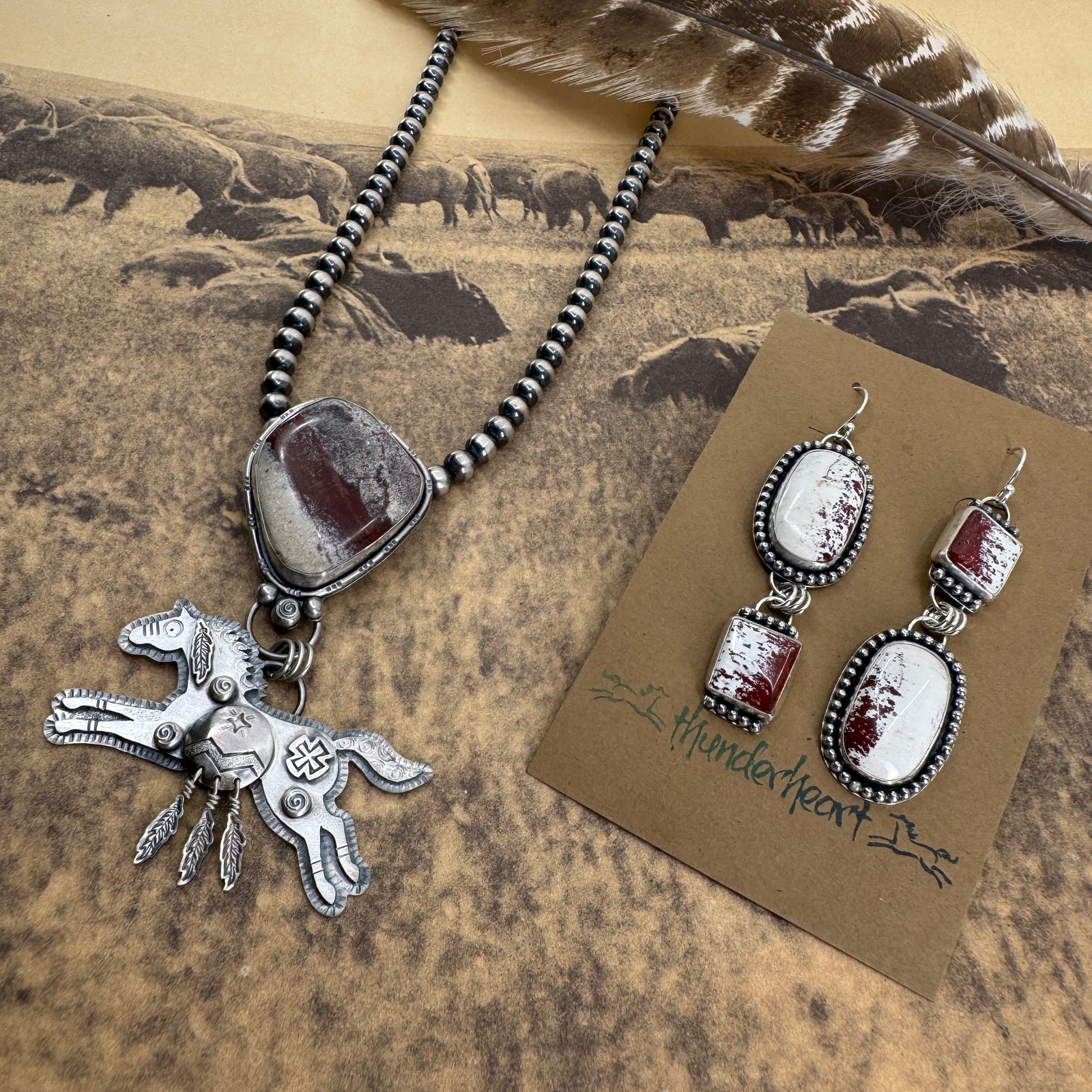 Sprit of the West Collection featuring Red Buffalo Turquoise jewelry with necklace and earrings, on a nature-themed background.