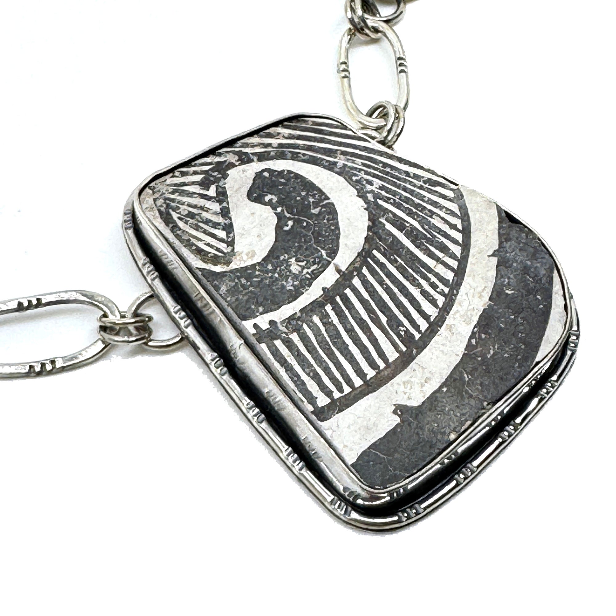 Detail of Sterling silver overlay buffalo necklace with authentic pottery shard, handcrafted by Thunderheart Jewelry in Arizona.