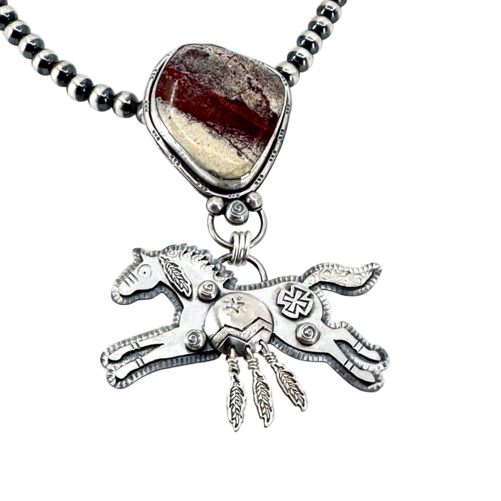 Detail of Sterling silver Spirit Horse necklace with rare red buffalo stone on Navajo pearls, handcrafted in Arizona by Thunderheart Jewelry.