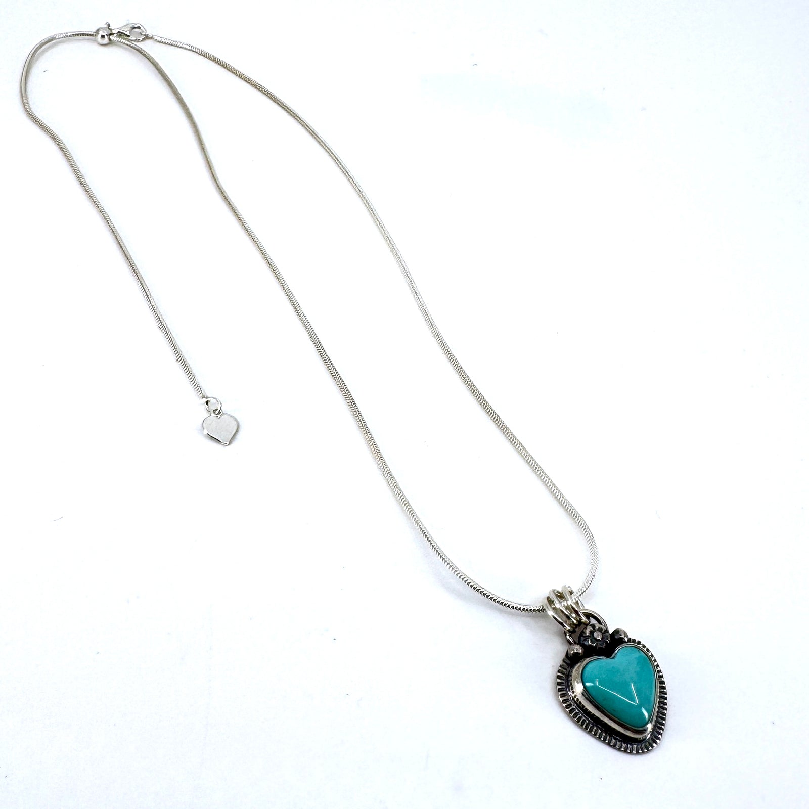 Necklace with a heart-shaped turquoise pendant on a white background