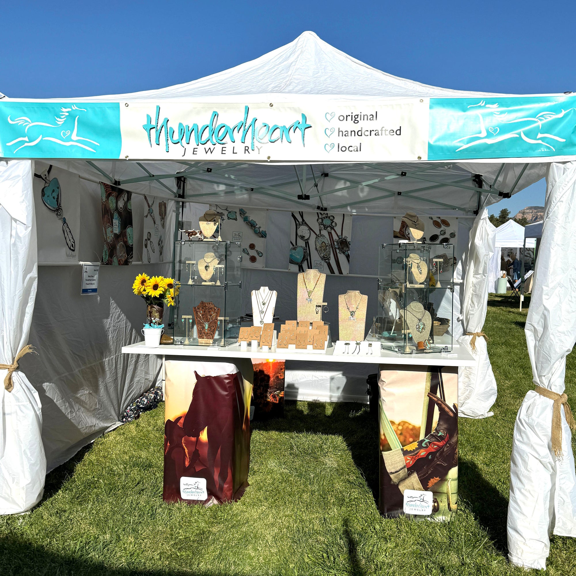 Tent with 'Thunderheart Jewelry' displaying various jewelry items at Sedona Arts Festival